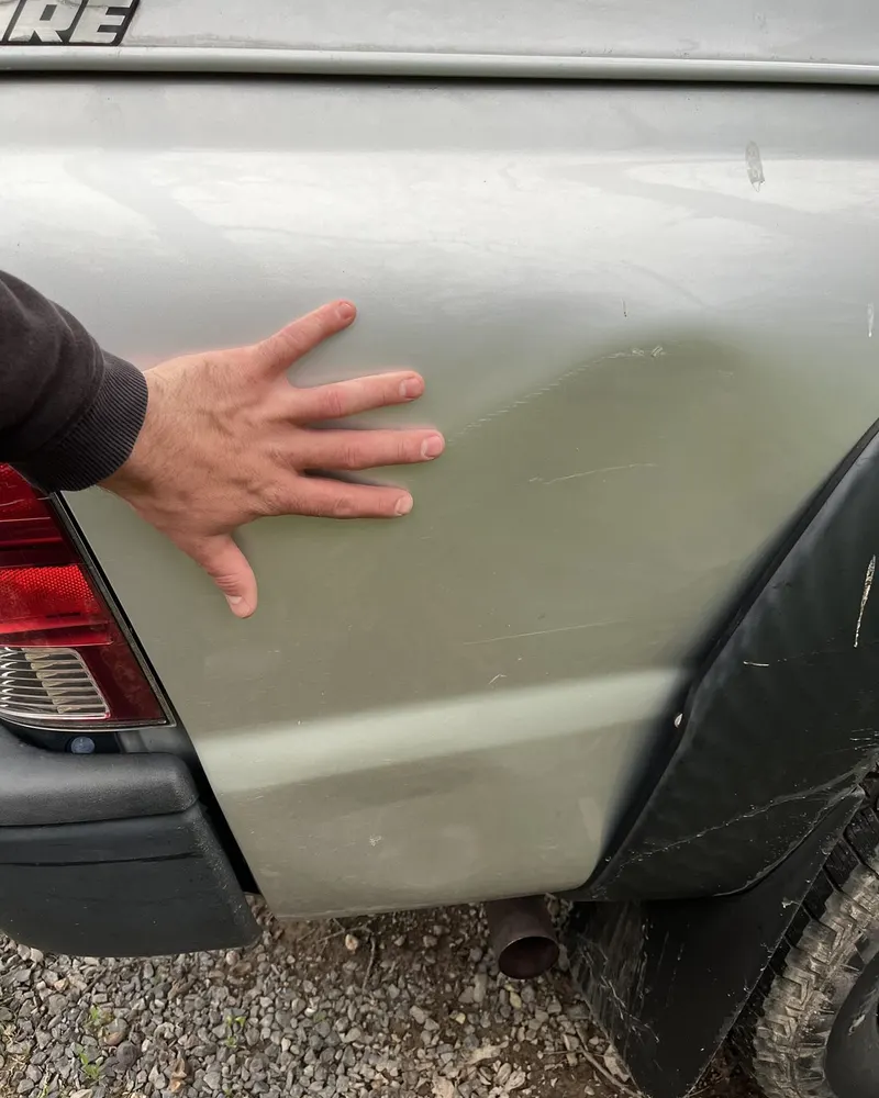 Before: truck bedside dent